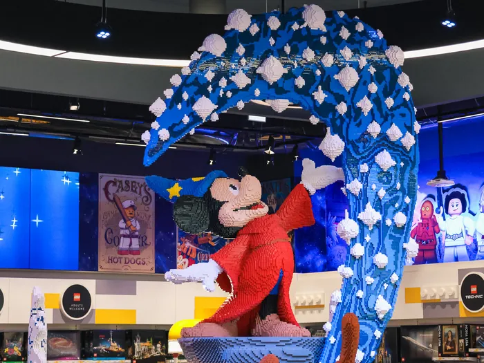 Giant LEGO sculpture of Sorcerer’s Apprentice Mickey under a wave, inside The LEGO Store.