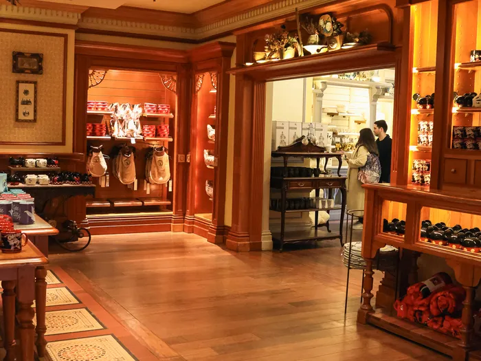 Wooden interior of Lilly’s Boutique with its patterned parquet floor and souvenir shelves, at Disneyland Paris.