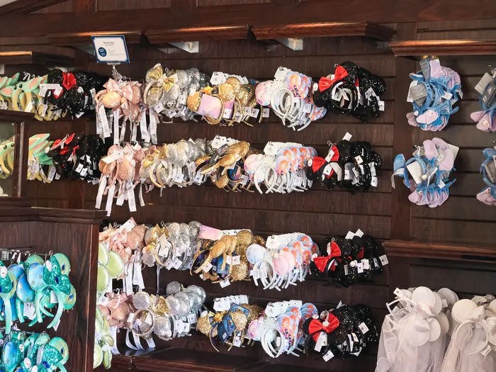 Wall of multicoloured Mickey ear headbands, with sequins and bows, at Studio Photo at Disneyland Paris