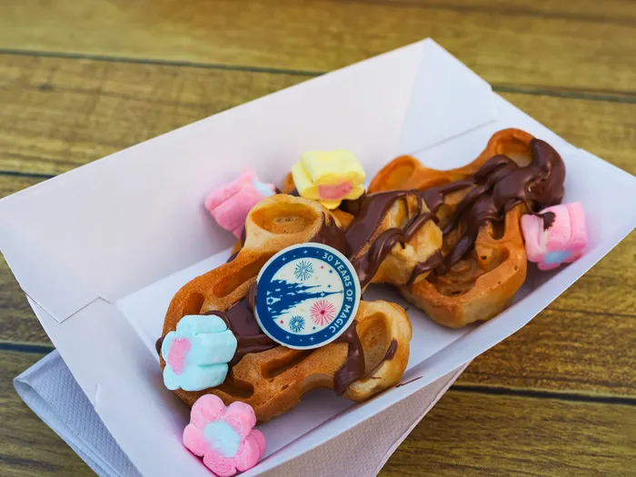 Gaufre nappée de chocolat garnie de guimauves colorées dans une barquette au Cool Post, Adventureland